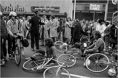 A black and white photo of a crowd in front of Bicycle Habitat.